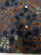 Louis Vuitton short-sleeve shirt fabric close-up with button detail on multicolor print