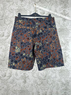 Men's patterned shorts with multicolor camo print, shown front on hanger