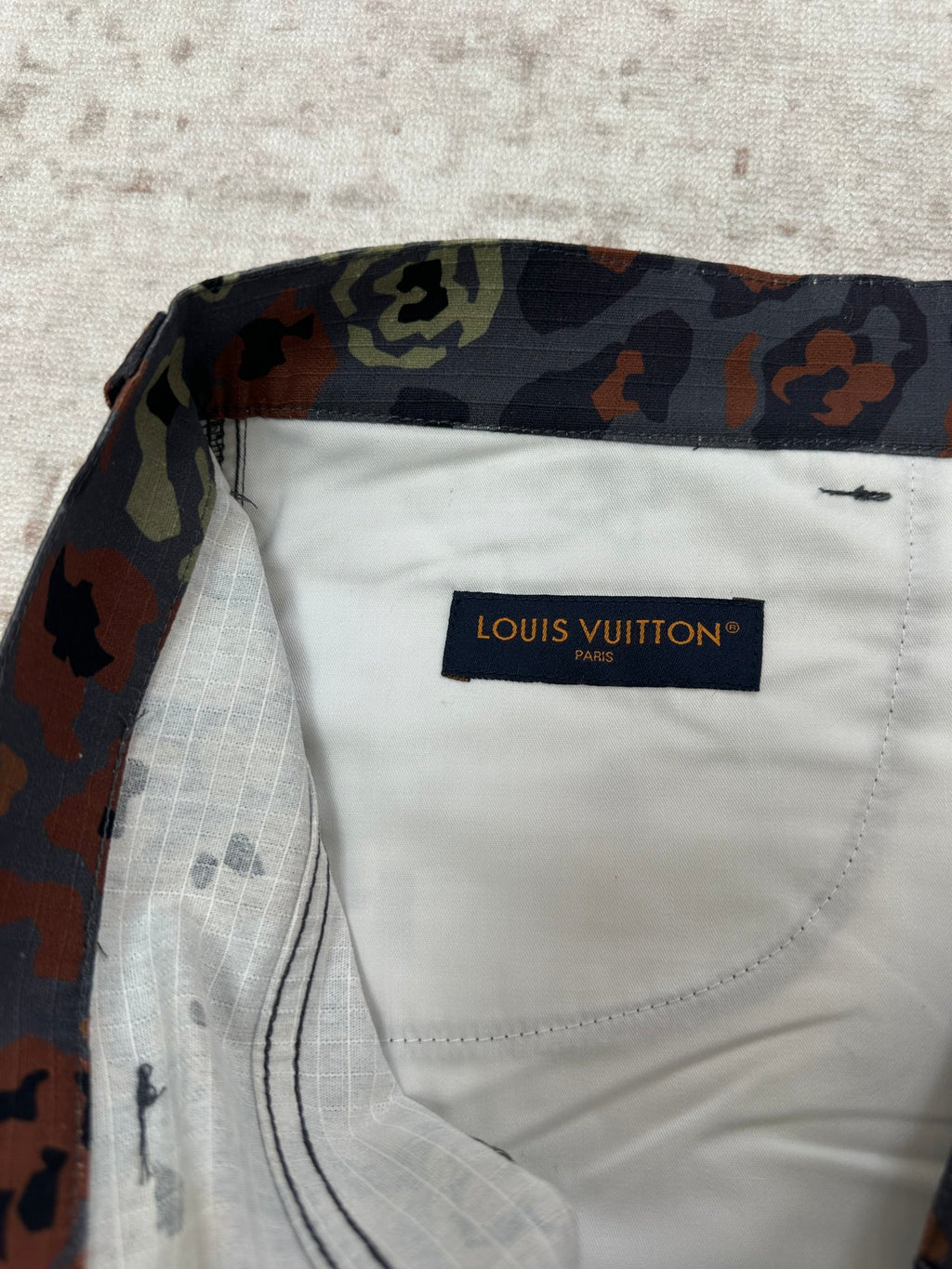 Patterned shorts interior pocket lining with Louis Vuitton Paris label