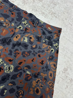 Patterned shorts front corner with belt loops, button details, and pockets