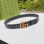 Gucci leather belt in dark black with gold-tone interlocking buckle and punch holes