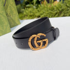 Gucci leather belt in dark black with gold-tone interlocking buckle, shown at angle