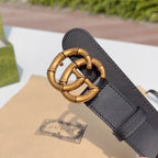 Gucci leather belt buckle close-up on dark black leather strap with gold-tone hardware