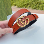 Gucci belt close-up: red leather strap with gold interlocking buckle and black underside