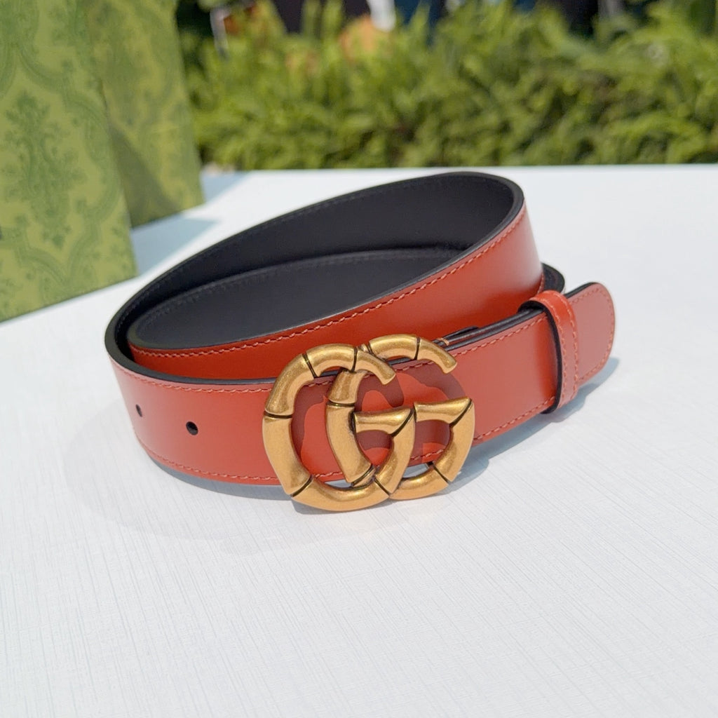 Gucci red leather belt with gold buckle and black back side visible