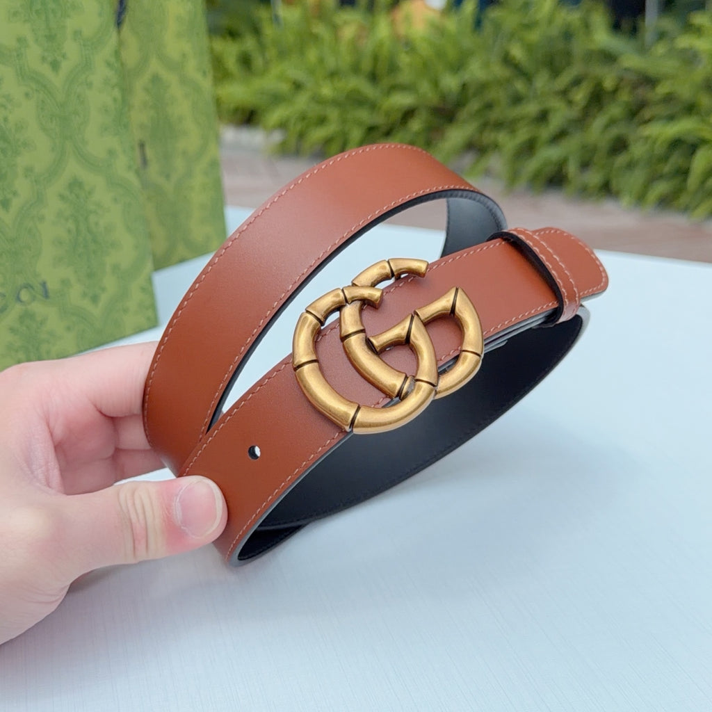 Tan leather belt with gold-tone buckle, side view