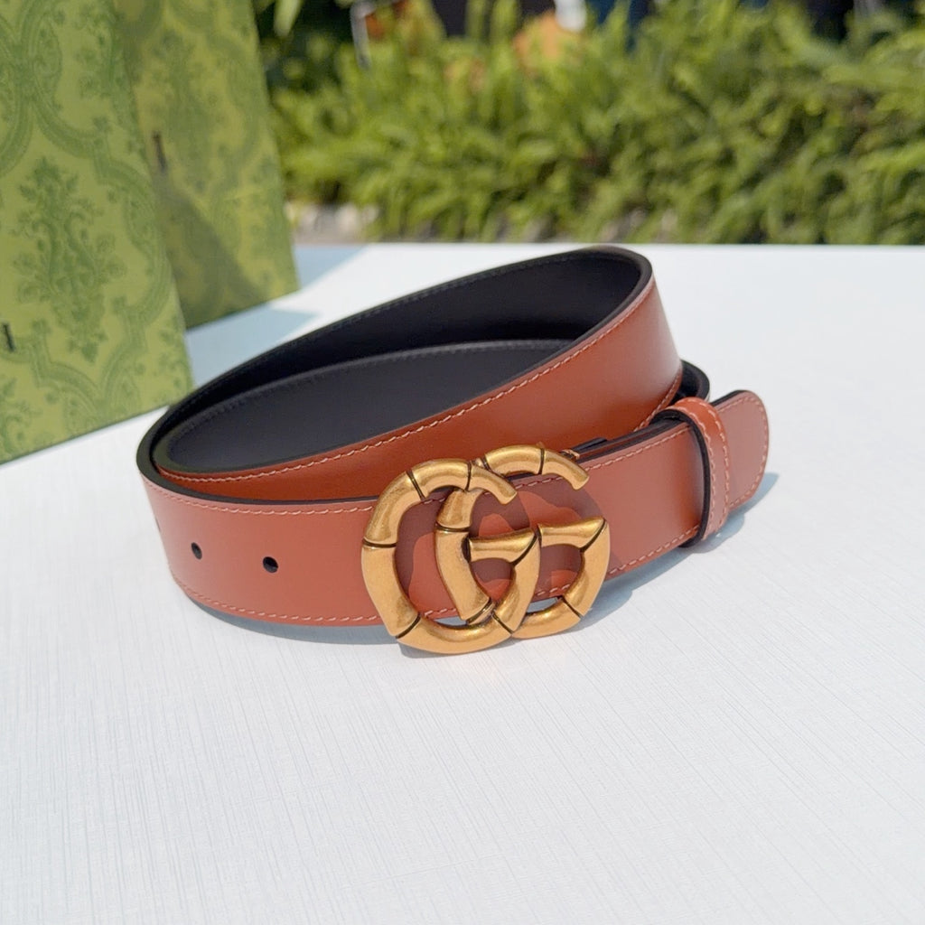 Tan leather belt with gold-tone buckle and adjustable holes