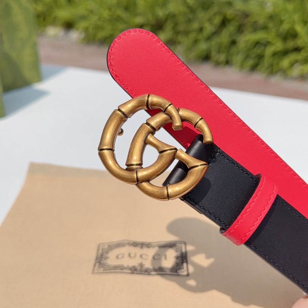 Gucci leather belt close-up: gold double-G buckle and red leather underside