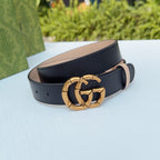 Gucci belt with gold-tone double-G buckle, tan inner strap, dark leather