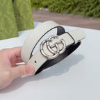 Cream leather belt with silver-tone double G buckle, visible holes and loop