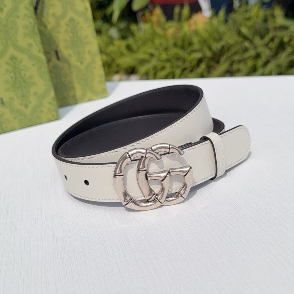 Cream leather belt with silver-tone double G buckle and dark interior, angled view