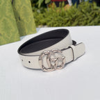 Cream leather belt with silver-tone double G buckle and dark interior, angled view