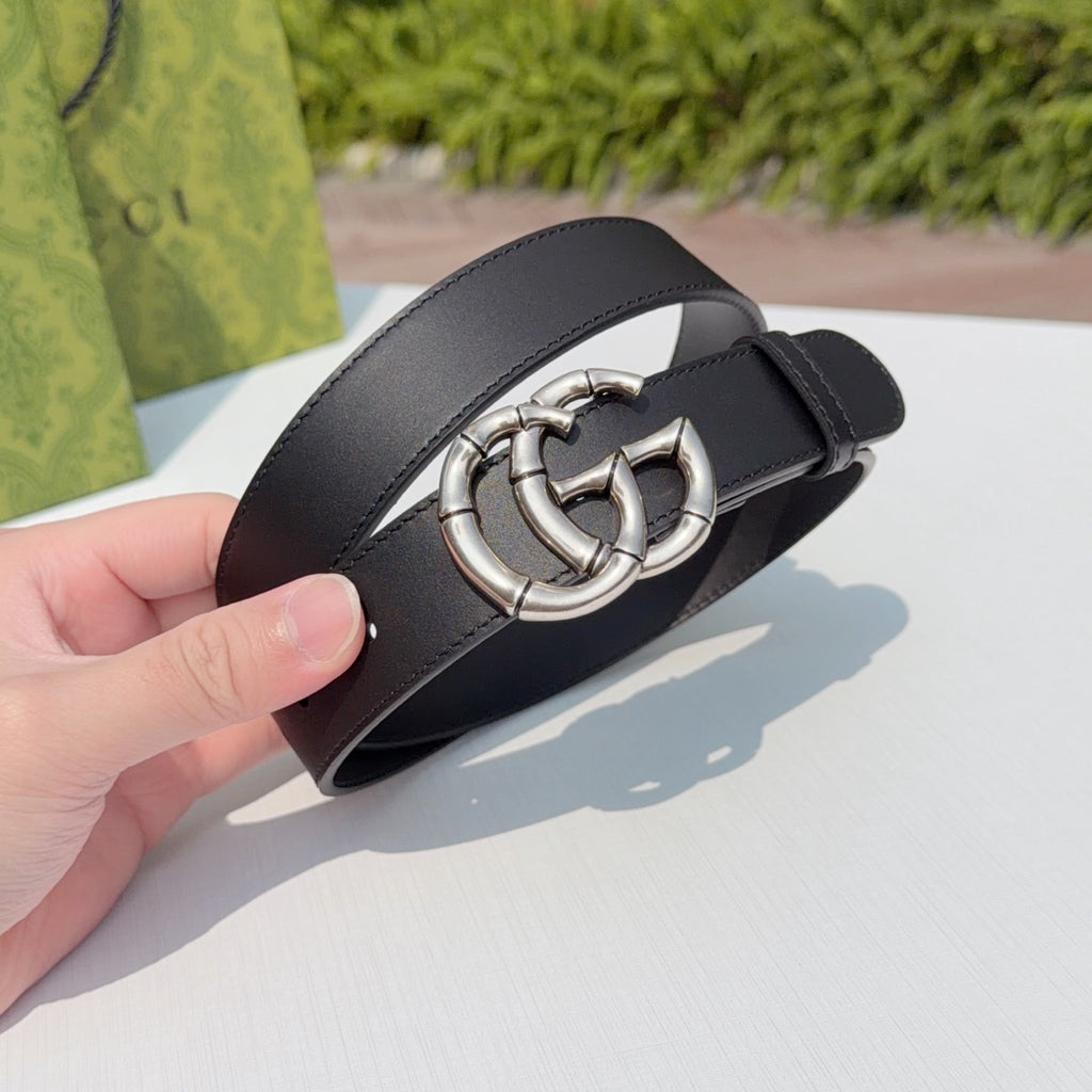 Gucci belt close-up on dark leather with silver double-G buckle