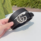 Gucci belt close-up on dark leather with silver double-G buckle