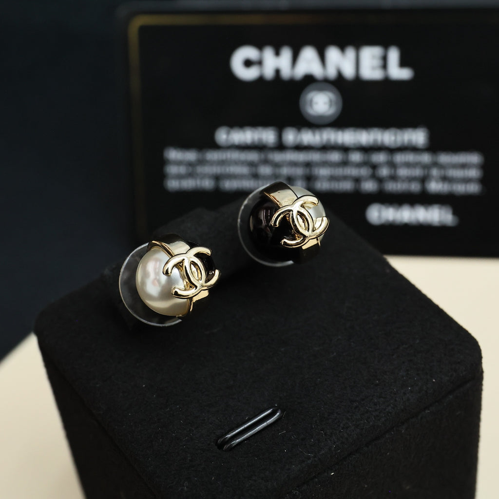 Pair of Chanel stud earrings with faux pearl and gold-tone CC on black enamel