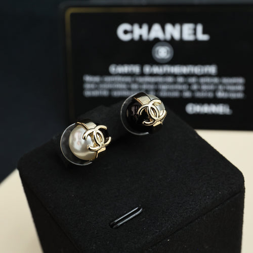 Pair of Chanel stud earrings with faux pearl and gold-tone CC on black enamel