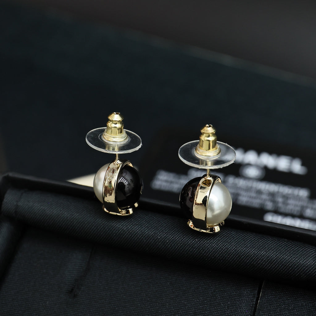 Chanel stud earrings with round faux pearl fronts and gold-tone CC details, black enamel