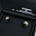 Pair of Chanel stud earrings with gold-tone CC and white faux pearls on black base