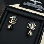 Gold-tone earrings with black and pearl drop pendants in black display box