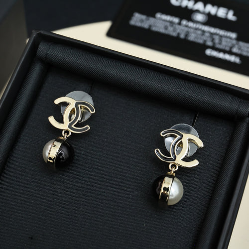 Gold-tone earrings with black and pearl drop pendants in black display box