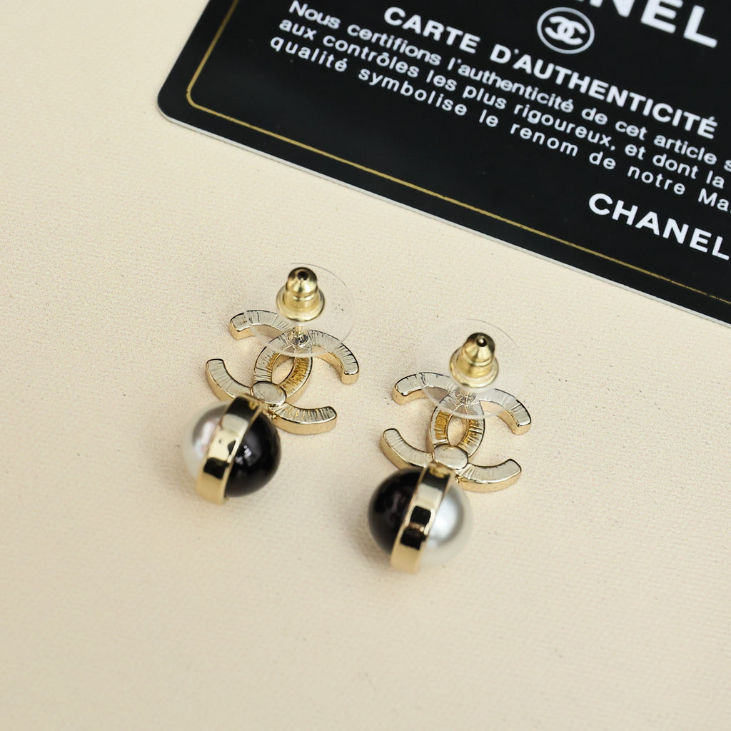 Gold-tone logo earrings with black and pearl drop pendants on card