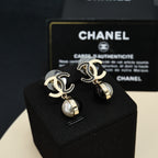 Gold-tone and silver-tone logo earrings with black and pearl drop pendants