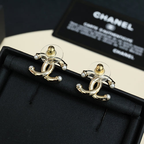 Chanel gold-tone stud earrings with interlocking CC logo and pearl-like accents
