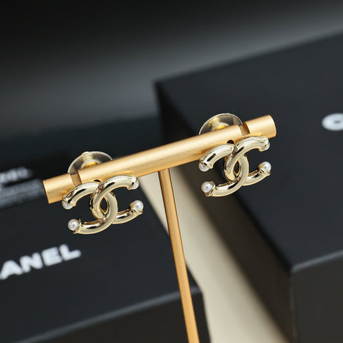 Chanel gold-tone clip-style earrings with interlocking CC logo and pearl-like beads