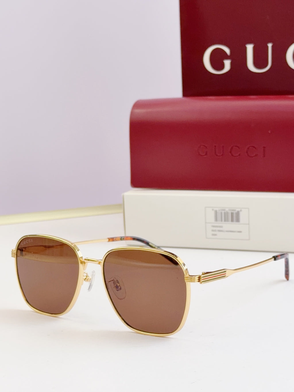 Gucci glasses with brown-tinted lenses and gold round frames