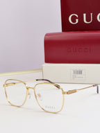 Gucci glasses with clear lenses and gold metal round frames, side view