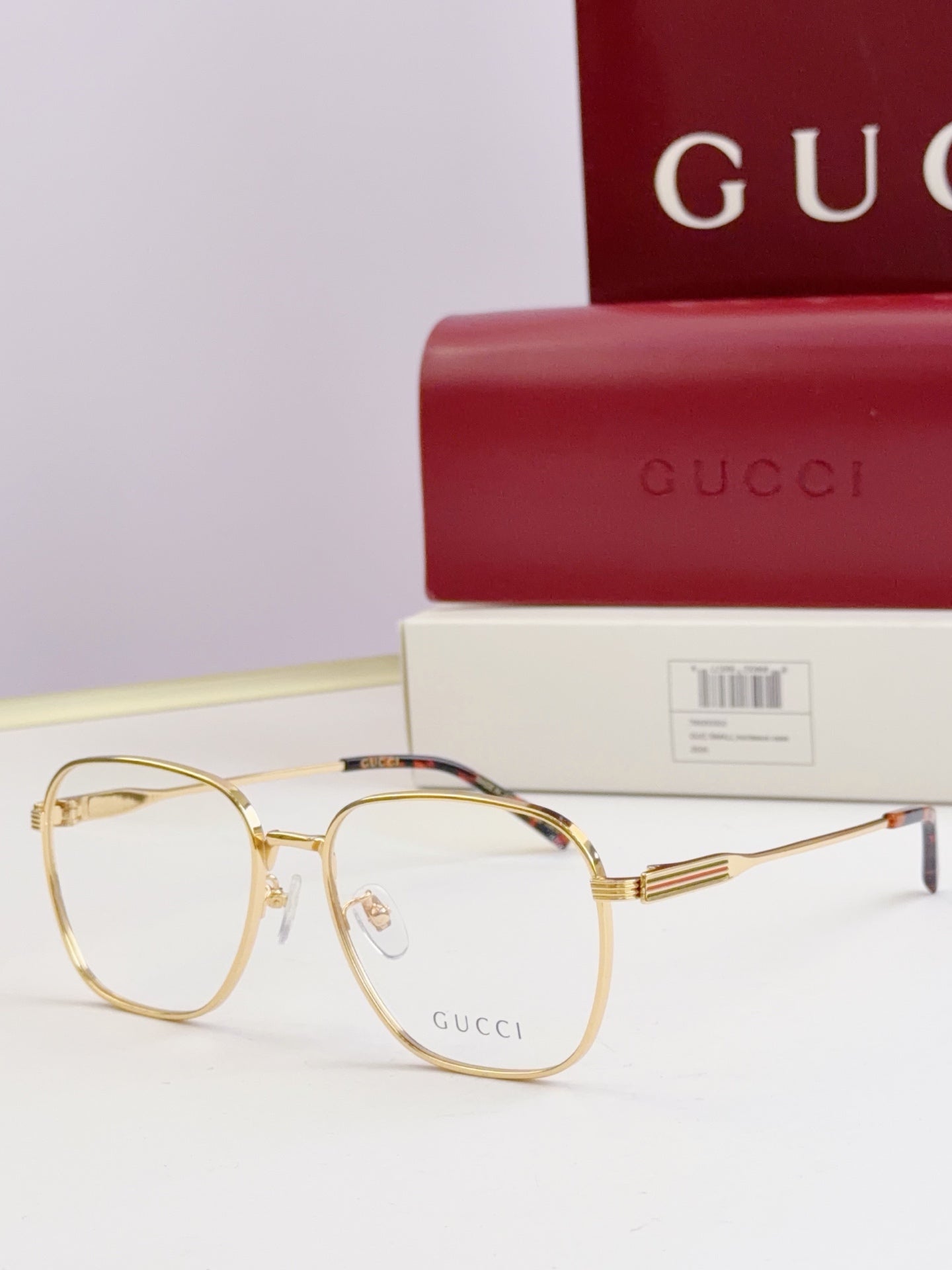 Gucci glasses with clear lenses and gold metal round frames, side view