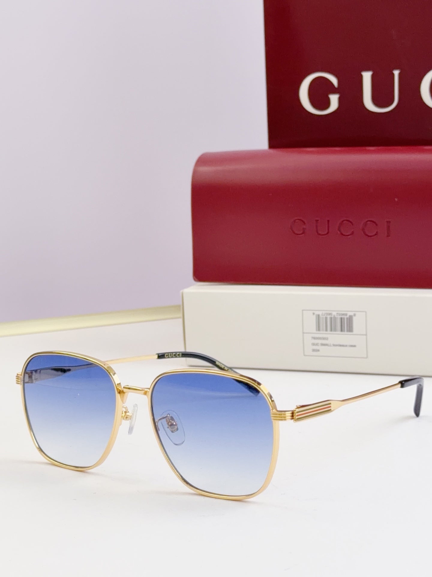 Gucci glasses with blue-tinted lenses and gold round frames