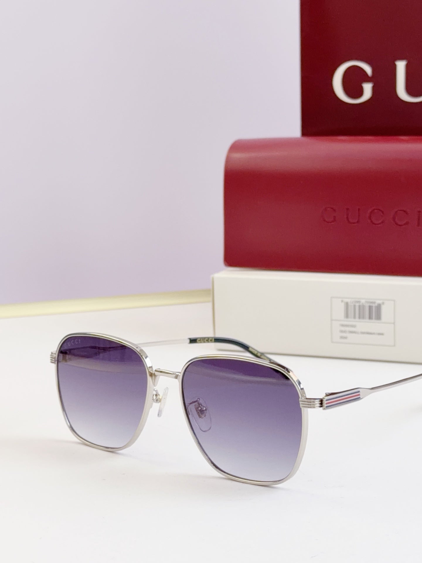 Gucci glasses with purple-tinted lenses and silver round frames