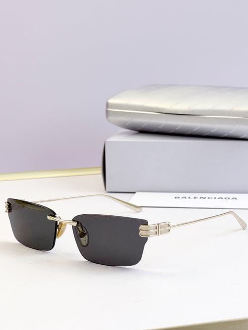 Sunglasses with dark lenses and gold-tone rectangular frame