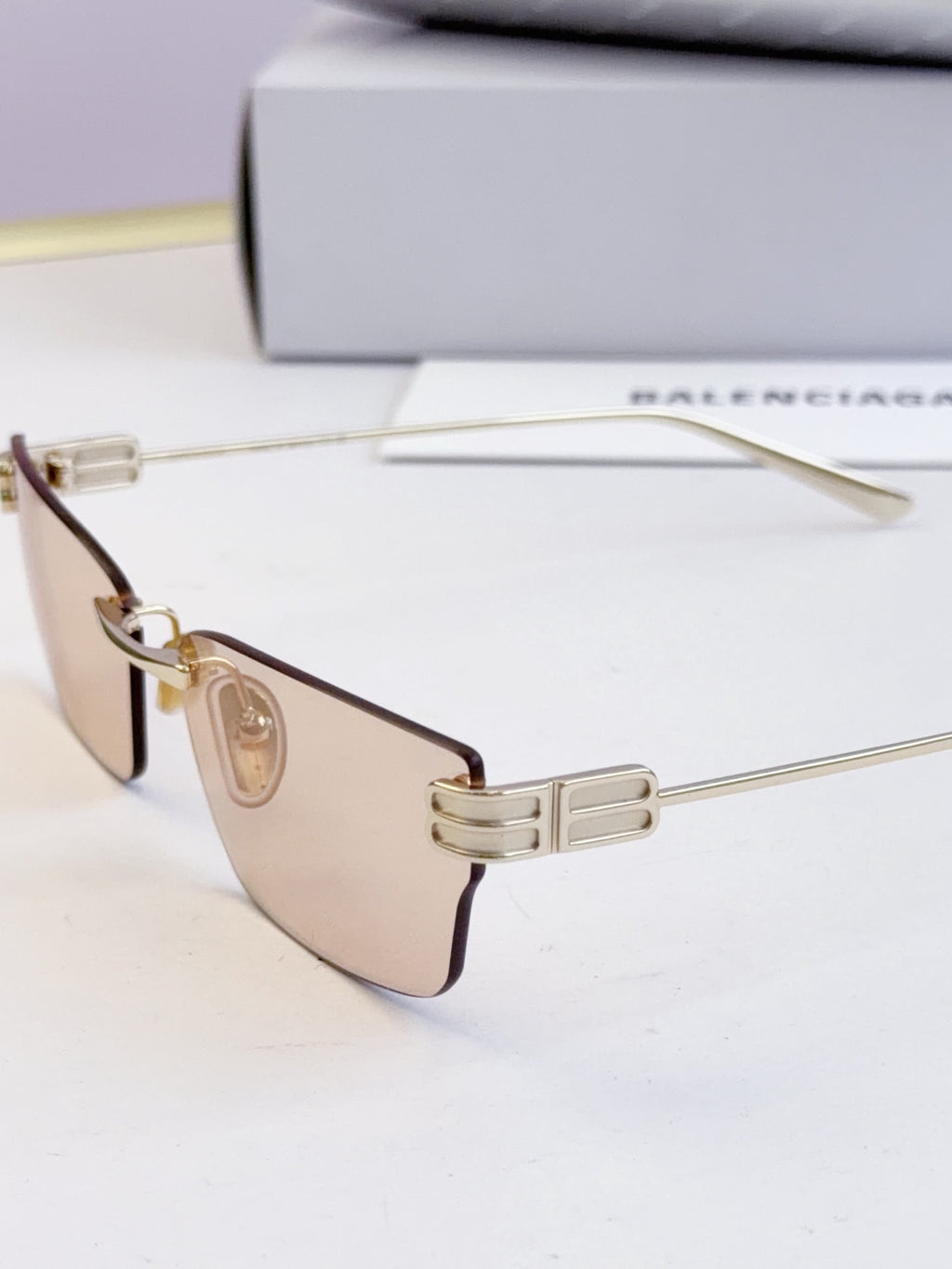 Sunglasses with dark lenses and gold-tone thin metal frame