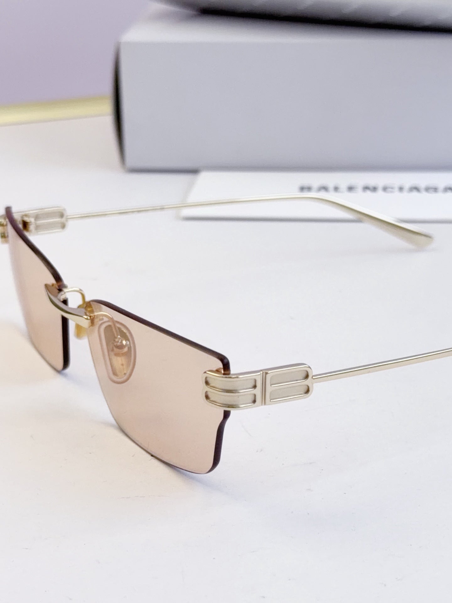 Sunglasses with dark lenses and gold-tone thin metal frame