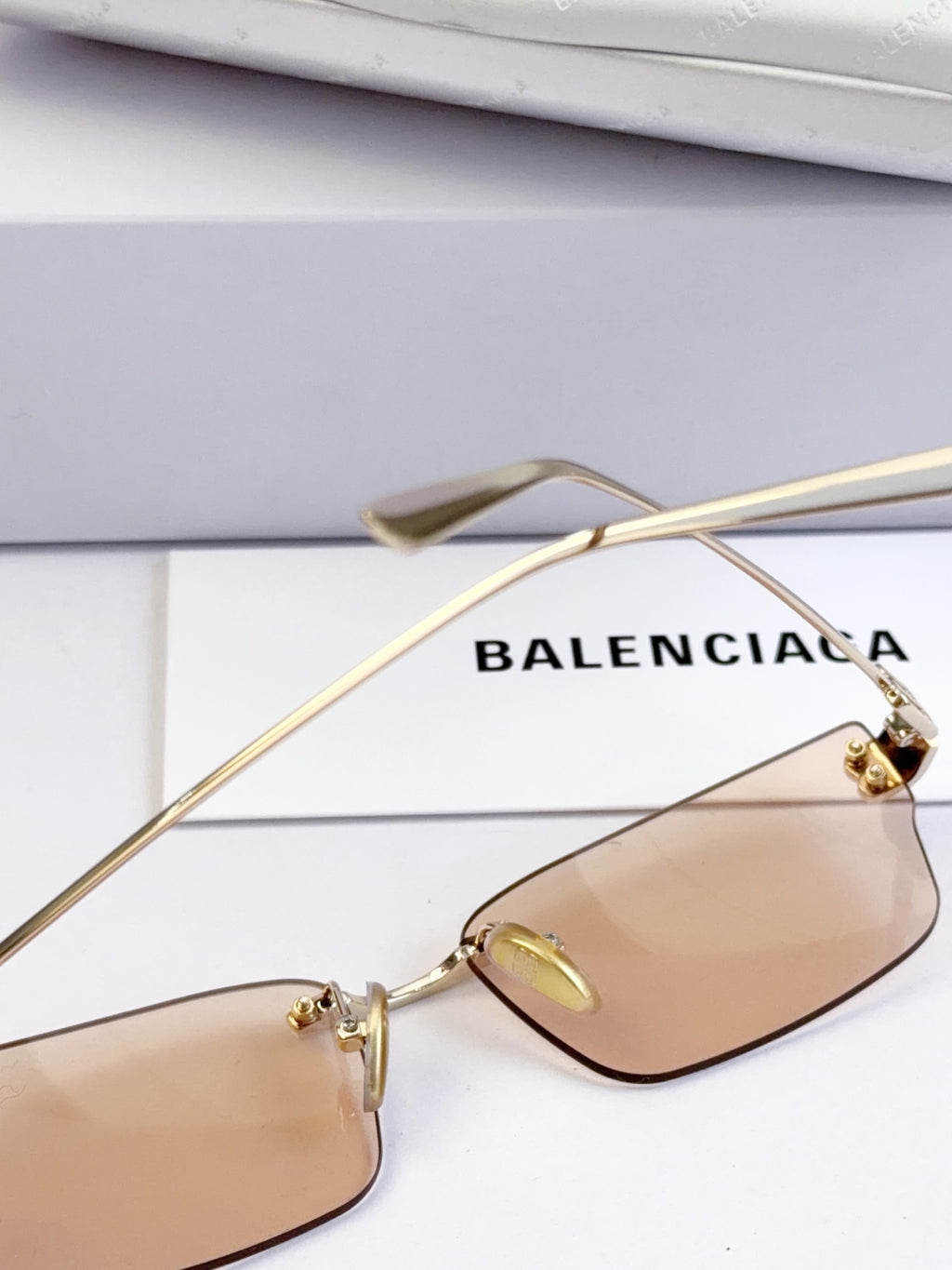 Sunglasses with tan lenses and gold-tone thin metal frame