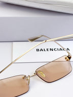 Sunglasses with tan lenses and gold-tone thin metal frame
