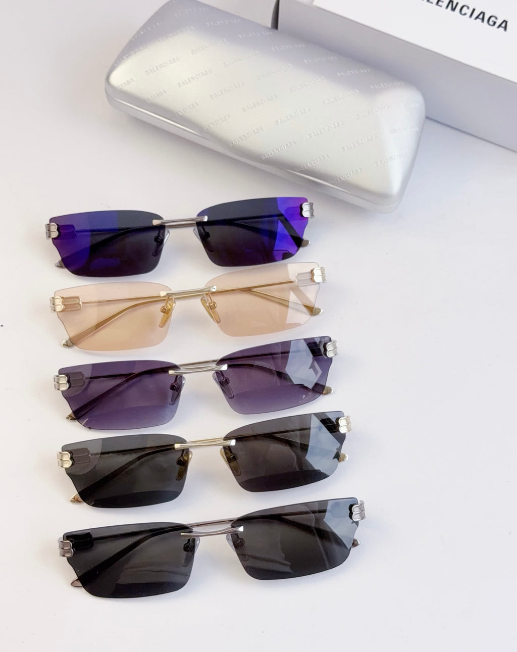 Set of sunglasses with dark purple, tan, violet, and black lenses; gold-tone frames