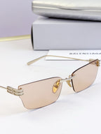 Sunglasses with light tan lenses and gold-tone thin metal frame