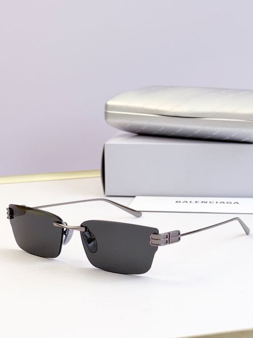 Sunglasses with black lenses and gold-tone rectangular frame
