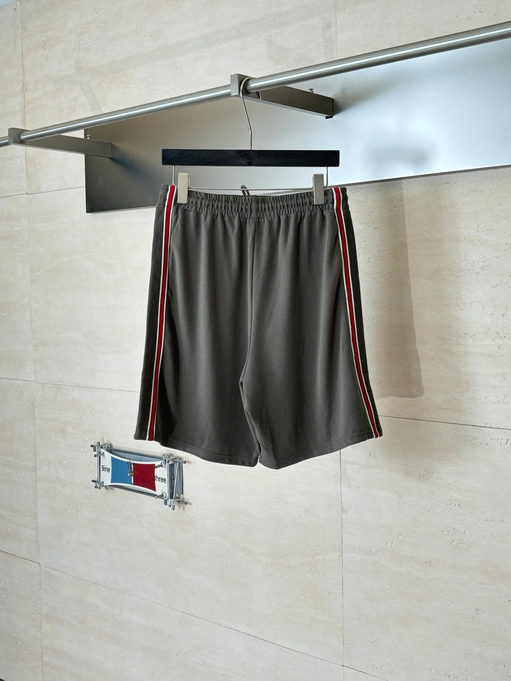Dark gray Gucci shorts on hanger, elastic waistband, drawstring, red and green stripe