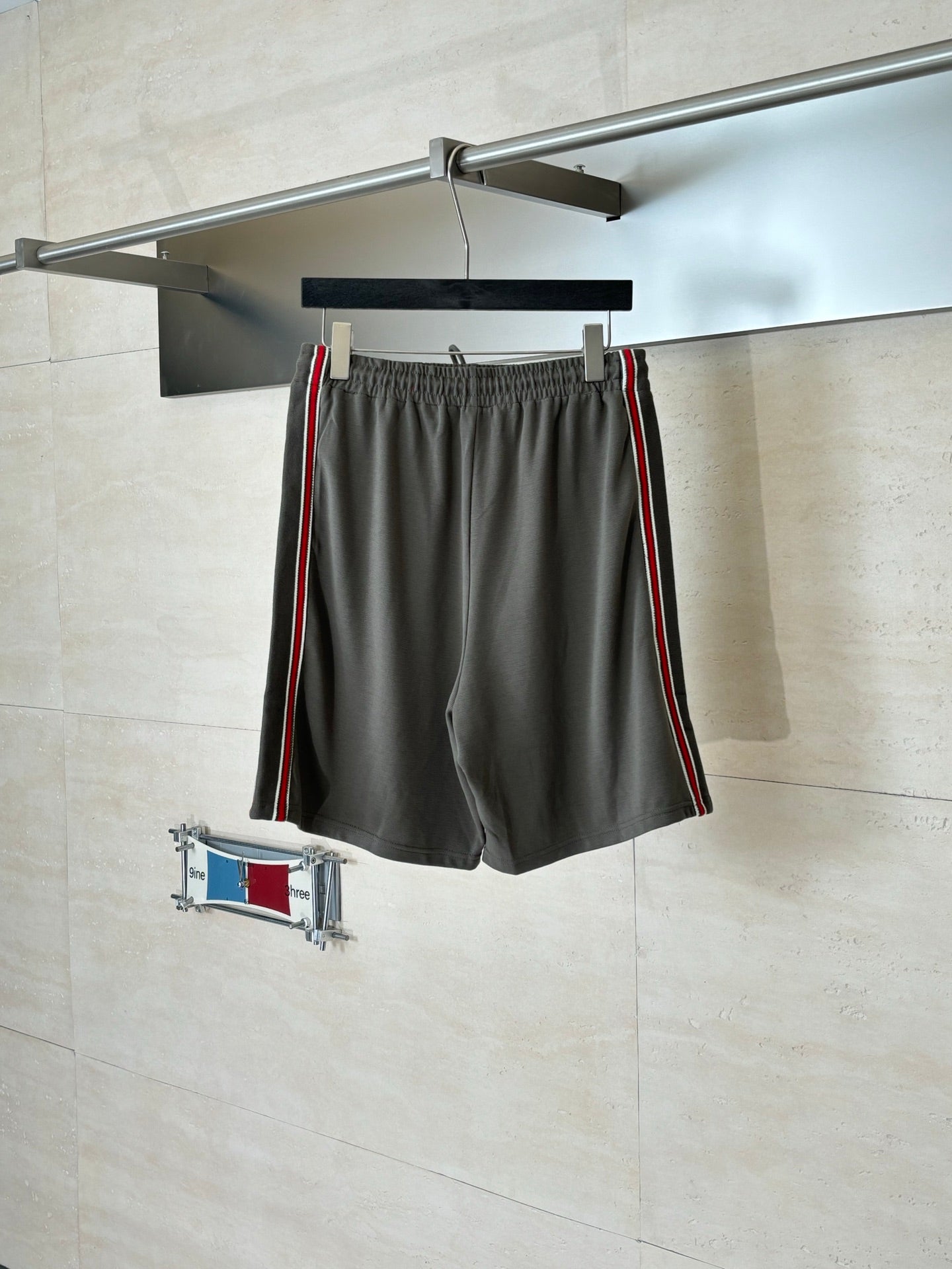 Dark gray Gucci shorts on hanger, elastic waistband, drawstring, red and green stripe