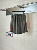 Dark gray Gucci drawstring shorts with elastic waistband and side web stripe