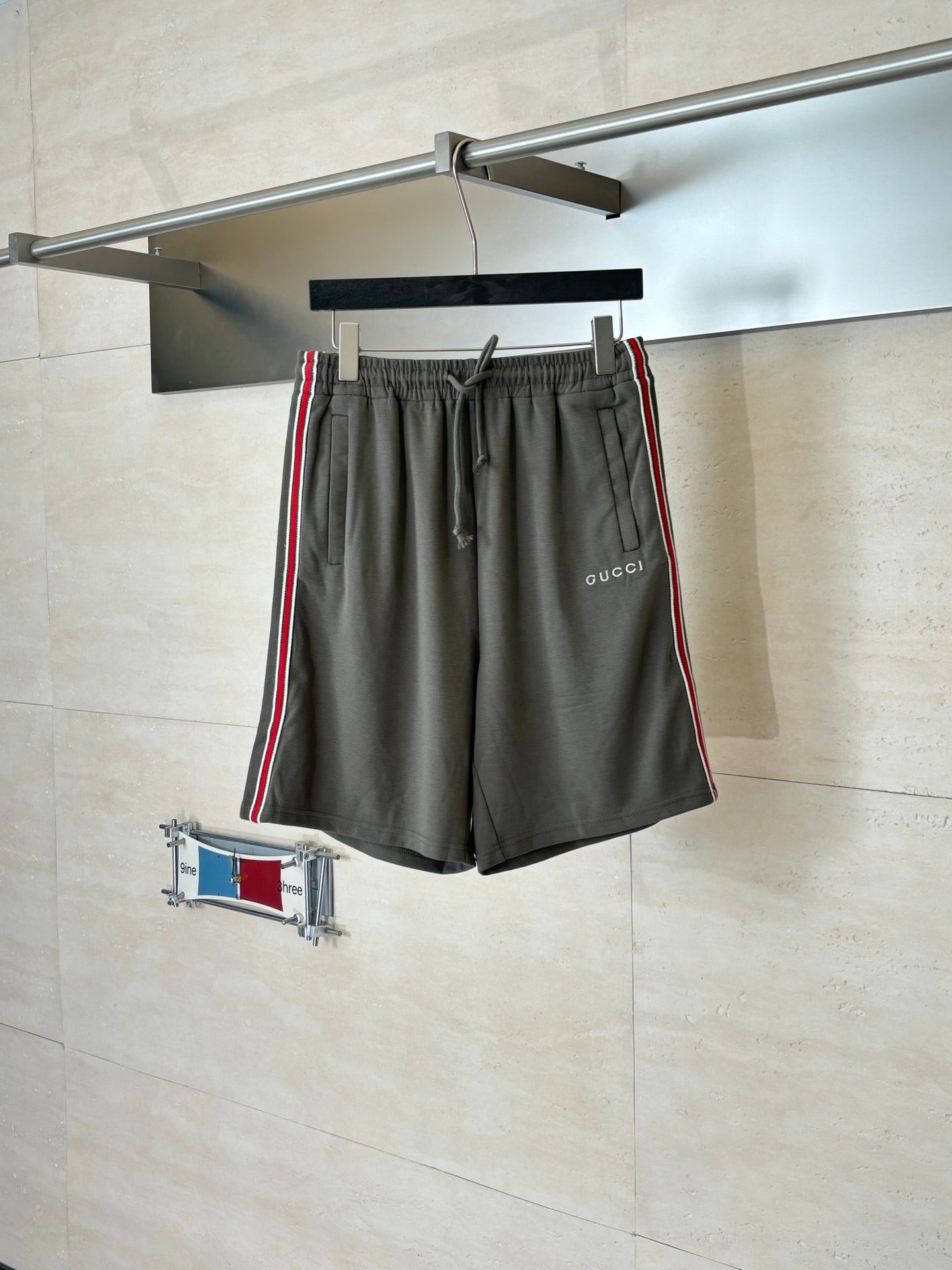 Dark gray Gucci drawstring shorts with elastic waistband and side web stripe