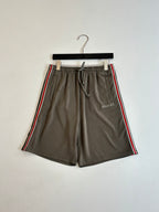 Dark gray Gucci drawstring shorts with side stripe and woven logo