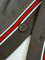 Gucci dark gray fabric close-up with red/green/white stripe and gold logo button