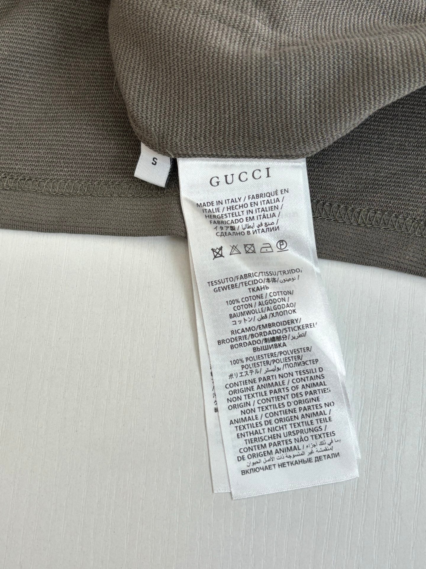 Dark gray Gucci shorts with interior size and care label