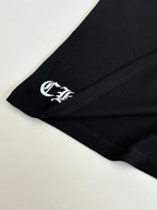 Black long-sleeve shirt sleeve cuff with small white logo print