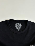 Black long-sleeve crewneck collar with round logo patch